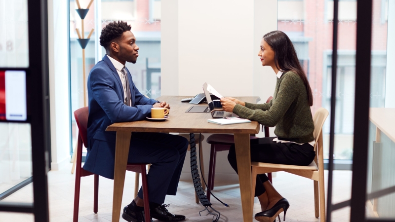 Businesswoman Interviewing Male Job Candidate In Meeting Room